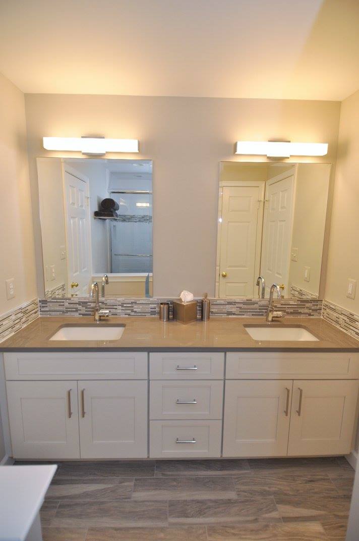 Bathroom remodel with white cabinetry and dual sinks