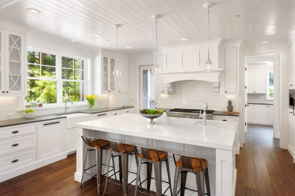 Open concept kitchen with white cabinetry